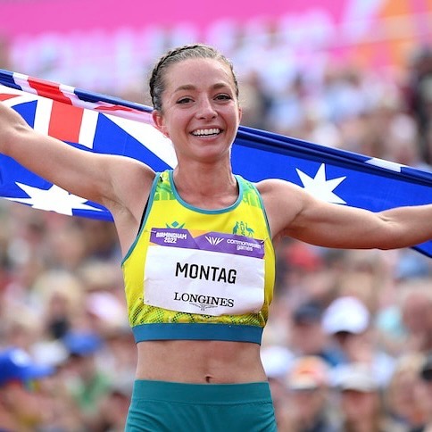 Jemima Montag with Australian flag as she crosses the line
