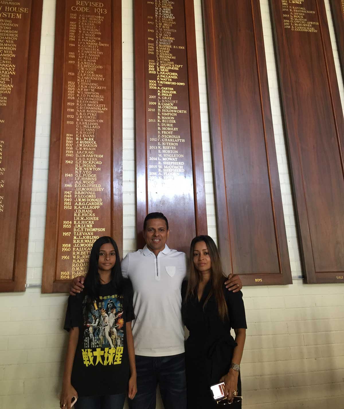 Nilantha Ratanayake (OW1987) at centre, with his daughter Dharini at left and wife Dayanthi at right, standing proudly in front of the Honour Boards at the St Kilda Road Campus